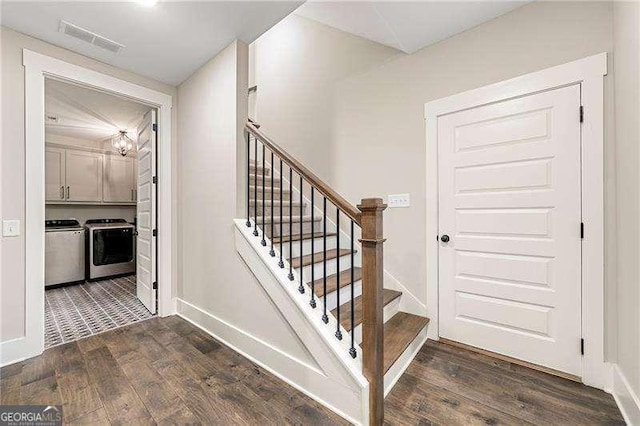 131 Forsyth Park Ln, Woodstock, GA 30188 - staircase with washing machine and clothes dryer, wood finished floors, a chandelier, and baseboards