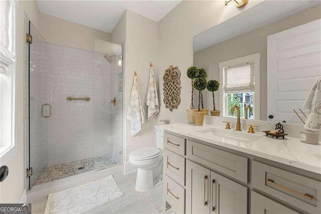 131 Forsyth Park Ln, Woodstock, GA 30188 - bathroom featuring toilet, vanity, a stall shower, and tile patterned floors