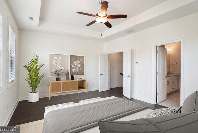 4202 Deming Cir, Sandy Springs, GA 30342 - bedroom with wood finished floors, a tray ceiling, connected bathroom, and ceiling fan
