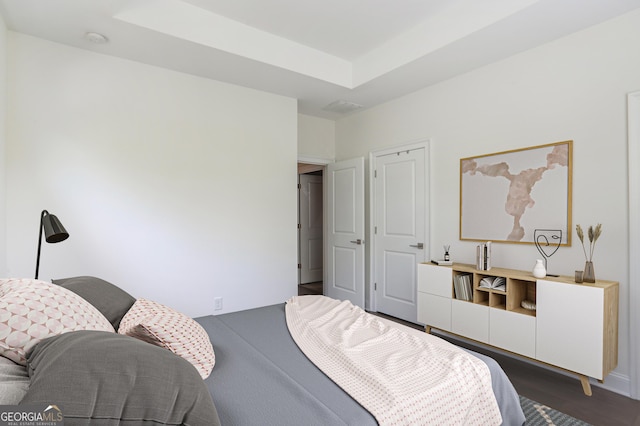 4202 Deming Cir, Sandy Springs, GA 30342 - bedroom featuring dark wood-type flooring and a raised ceiling