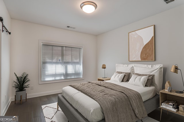 4202 Deming Cir, Sandy Springs, GA 30342 - bedroom with a barn door and dark wood-type flooring
