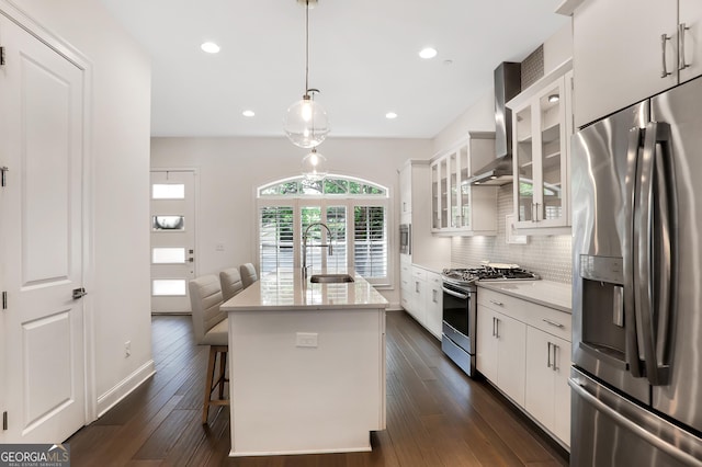 4202 Deming Cir, Sandy Springs, GA 30342 - kitchen featuring appliances with stainless steel finishes, wall chimney exhaust hood, white cabinetry, decorative backsplash, and recessed lighting