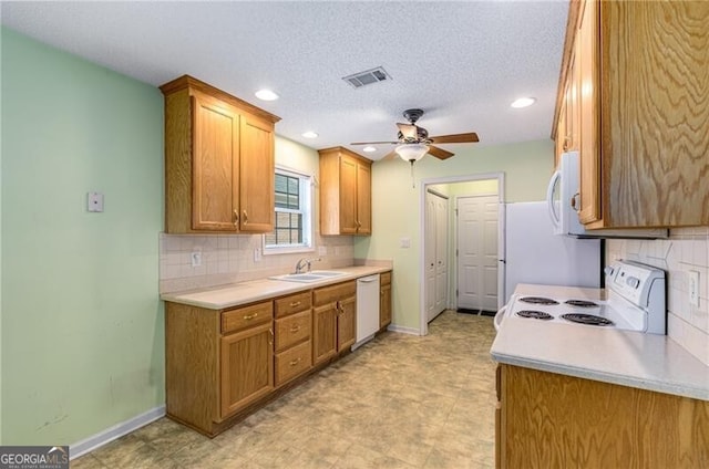 115 Pinnacle Ln, Mcdonough, GA 30253 - kitchen with white appliances, a sink, a ceiling fan, light countertops, and recessed lighting
