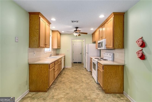 115 Pinnacle Ln, Mcdonough, GA 30253 - kitchen with white appliances, a sink, light countertops, recessed lighting, and a ceiling fan
