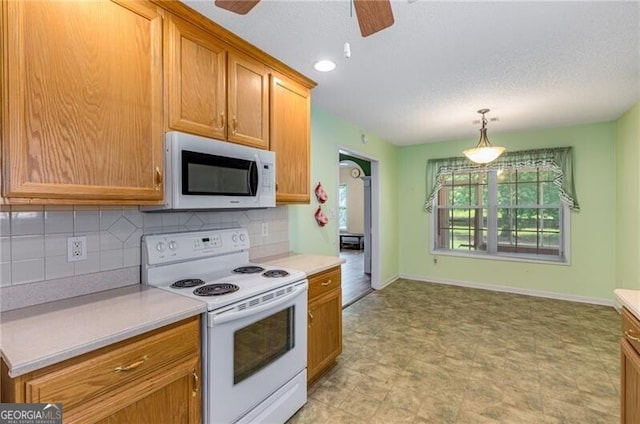 115 Pinnacle Ln, Mcdonough, GA 30253 - kitchen featuring white appliances, a ceiling fan, light countertops, and a textured ceiling
