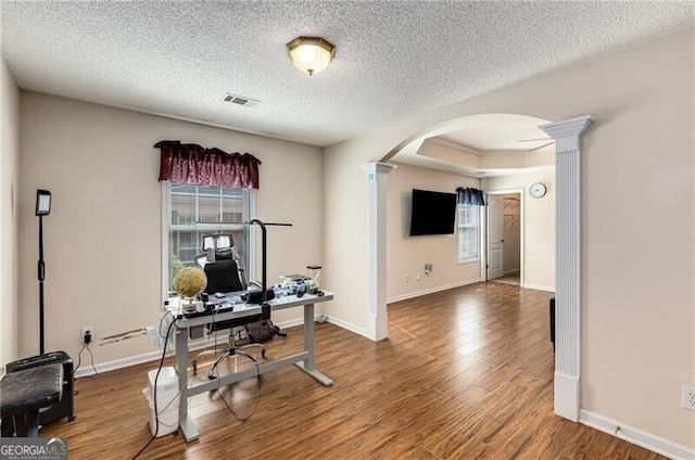 115 Pinnacle Ln, Mcdonough, GA 30253 - office area with arched walkways, ornate columns, wood finished floors, a textured ceiling, and baseboards
