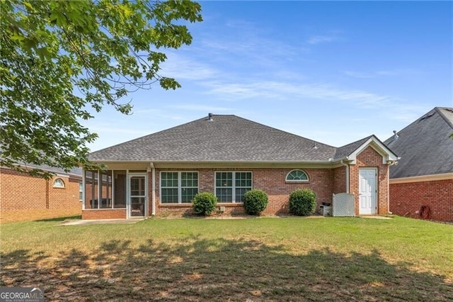 115 Pinnacle Ln, Mcdonough, GA 30253 - rear view of property featuring a sunroom, brick siding, a yard, and roof with shingles