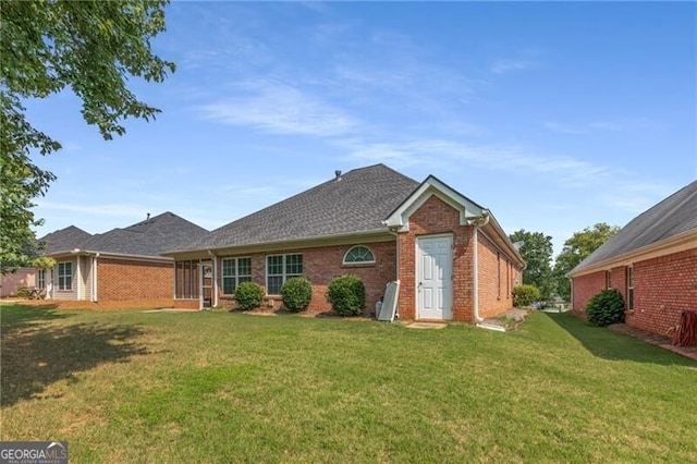 115 Pinnacle Ln, Mcdonough, GA 30253 - view of front facade featuring brick siding, a front yard, and a shingled roof