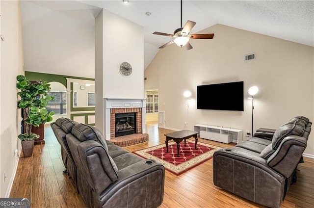 115 Pinnacle Ln, Mcdonough, GA 30253 - living room with high vaulted ceiling, a ceiling fan, wood finished floors, a fireplace, and baseboards