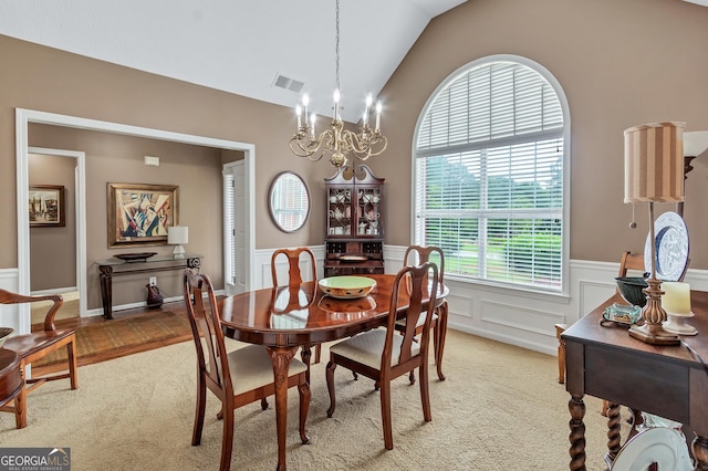 70 Merion Way, Newnan, GA 30265 - dining area with a chandelier, light carpet, a wainscoted wall, a decorative wall, and vaulted ceiling