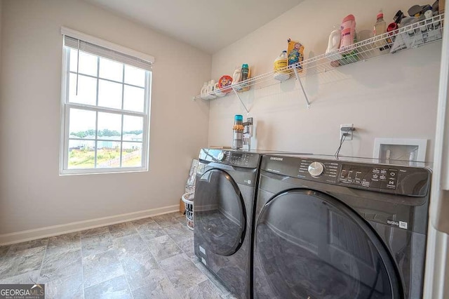 6827 Chataran Dr, Lithia Springs, GA 30122 - washroom with washing machine and dryer, healthy amount of natural light, baseboards, and stone finish floors