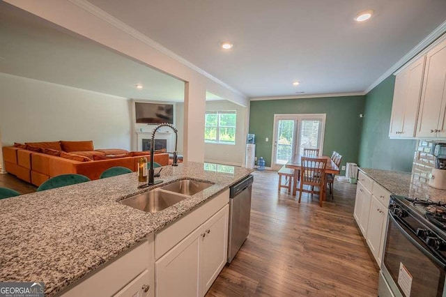 6827 Chataran Dr, Lithia Springs, GA 30122 - kitchen featuring a sink, dishwasher, gas stove, open floor plan, and ornamental molding