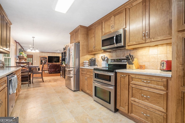 1310 Chilton Woods Rd, Rutledge, GA 30663 - kitchen featuring appliances with stainless steel finishes, brown cabinets, backsplash, open floor plan, and pendant lighting