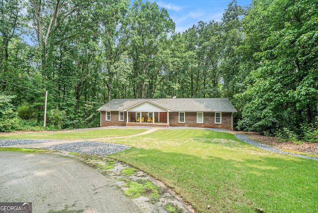1310 Chilton Woods Rd, Rutledge, GA 30663 - ranch-style house featuring brick siding, a porch, and a front lawn