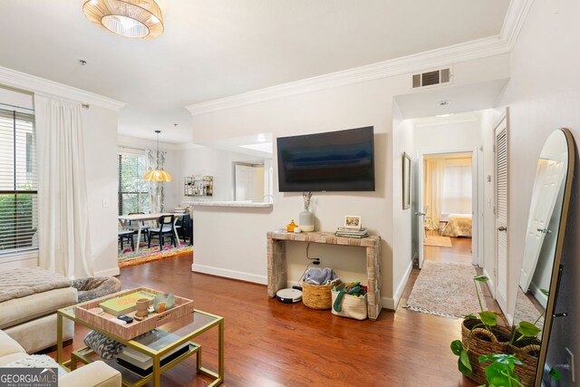 3777 Peachtree Rd NE Unit 1112, Brookhaven, GA 30319 - living room featuring wood finished floors, crown molding, and baseboards