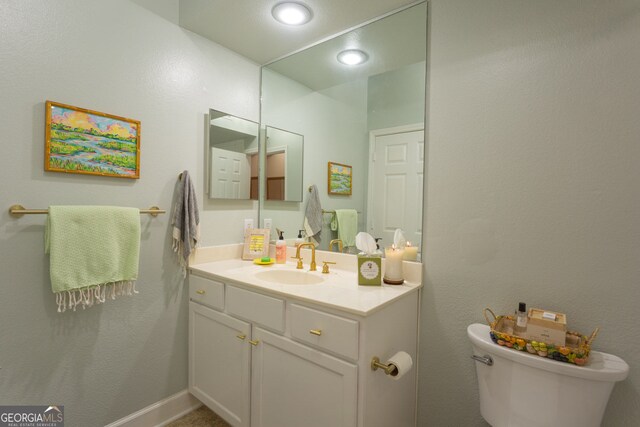 3777 Peachtree Rd NE Unit 1112, Brookhaven, GA 30319 - bathroom with vanity, toilet, recessed lighting, and baseboards