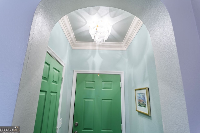 3777 Peachtree Rd NE Unit 1112, Brookhaven, GA 30319 - entryway with crown molding, a chandelier, arched walkways, and a textured wall