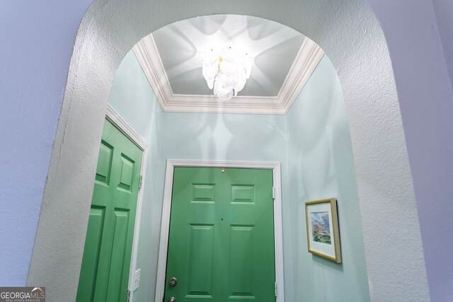 3777 Peachtree Rd NE Unit 1112, Brookhaven, GA 30319 - entryway with crown molding, a chandelier, arched walkways, and a textured wall
