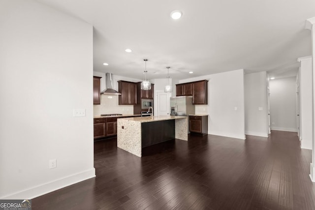 2855 Pilgrim Mill Rd, Cumming, GA 30041 - kitchen with wall chimney range hood, stainless steel appliances, recessed lighting, decorative backsplash, and a kitchen island with sink