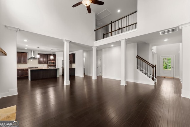 2855 Pilgrim Mill Rd, Cumming, GA 30041 - unfurnished living room featuring a ceiling fan, stairs, a high ceiling, dark wood-style flooring, and recessed lighting