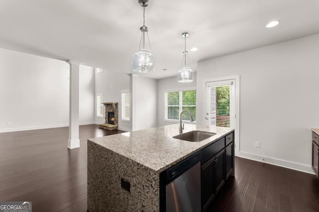 2855 Pilgrim Mill Rd, Cumming, GA 30041 - kitchen featuring a sink, dishwasher, dark wood finished floors, a stone fireplace, and baseboards