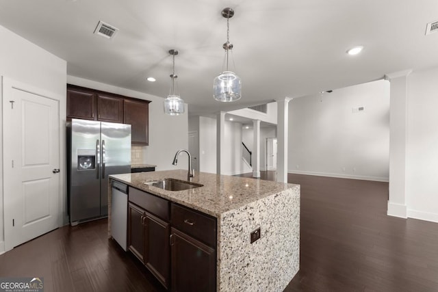 2855 Pilgrim Mill Rd, Cumming, GA 30041 - kitchen with stainless steel appliances, a sink, light stone countertops, dark wood-style flooring, and dark brown cabinetry