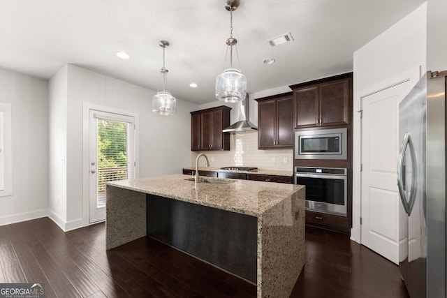 2855 Pilgrim Mill Rd, Cumming, GA 30041 - kitchen with stainless steel appliances, wall chimney range hood, a sink, dark wood finished floors, and dark brown cabinets