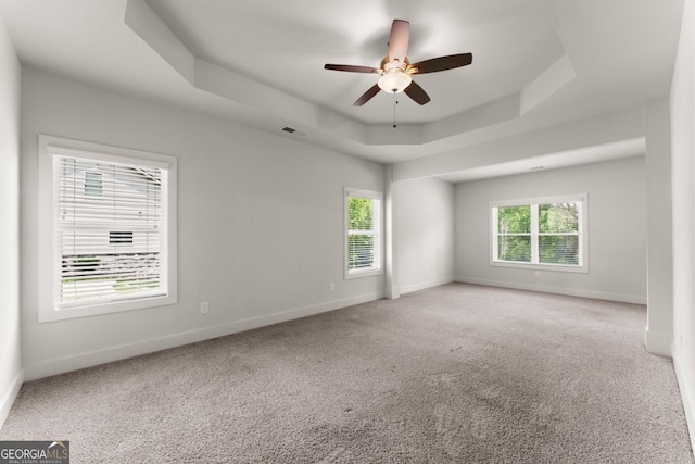 2855 Pilgrim Mill Rd, Cumming, GA 30041 - unfurnished room featuring a tray ceiling, ceiling fan, and carpet