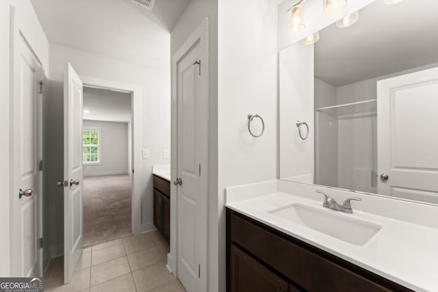 2855 Pilgrim Mill Rd, Cumming, GA 30041 - bathroom featuring vanity, tile patterned floors, baseboards, and a shower