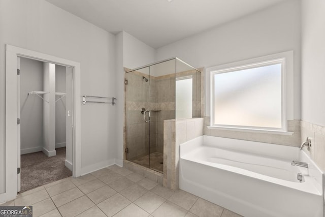 2855 Pilgrim Mill Rd, Cumming, GA 30041 - full bathroom with a garden tub, a shower stall, a walk in closet, and tile patterned floors