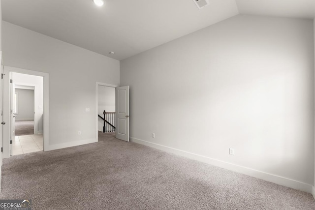 2855 Pilgrim Mill Rd, Cumming, GA 30041 - unfurnished bedroom with light carpet, vaulted ceiling, and connected bathroom