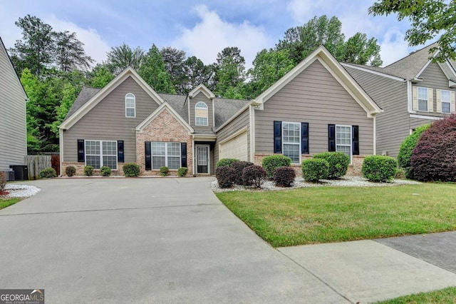 2842 Sedgeview Ln, Buford, GA 30519 - view of front of house with brick siding, an attached garage, driveway, central air condition unit, and a shingled roof
