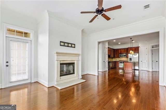 3635 Paces Cir Unit 1405, Atlanta, GA 30326 - unfurnished living room featuring dark wood-type flooring, a ceiling fan, ornamental molding, baseboards, and a glass covered fireplace