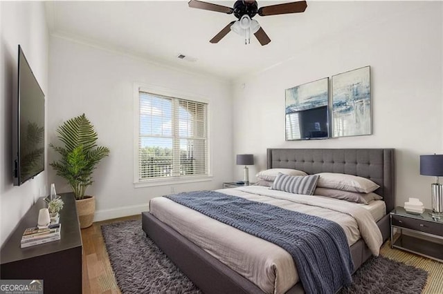 3635 Paces Cir Unit 1405, Atlanta, GA 30326 - bedroom featuring wood finished floors, baseboards, a ceiling fan, and crown molding