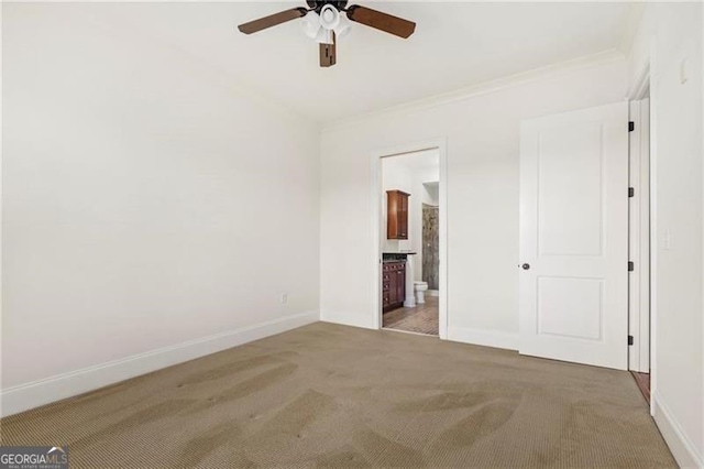 3635 Paces Cir Unit 1405, Atlanta, GA 30326 - unfurnished bedroom with light colored carpet, baseboards, crown molding, ensuite bath, and a ceiling fan