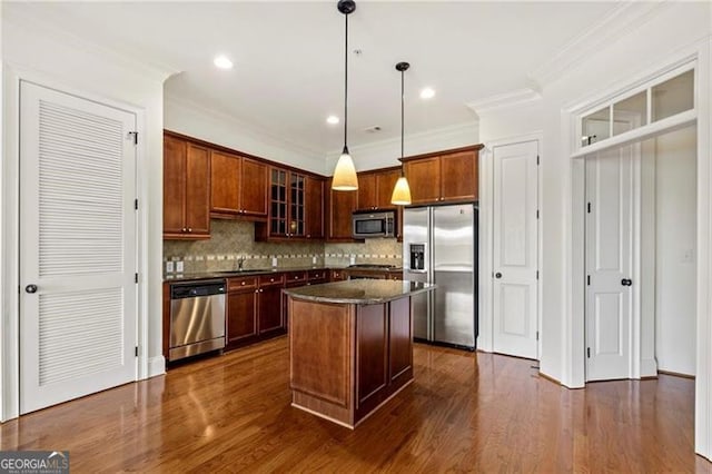 3635 Paces Cir Unit 1405, Atlanta, GA 30326 - kitchen with appliances with stainless steel finishes, tasteful backsplash, a kitchen island, glass insert cabinets, and dark wood-style flooring