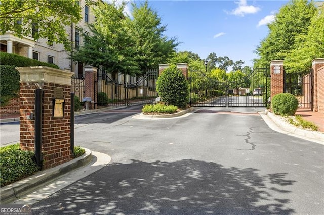 3635 Paces Cir Unit 1405, Atlanta, GA 30326 - view of asphalt street with curbs, a gated entry, and a gate