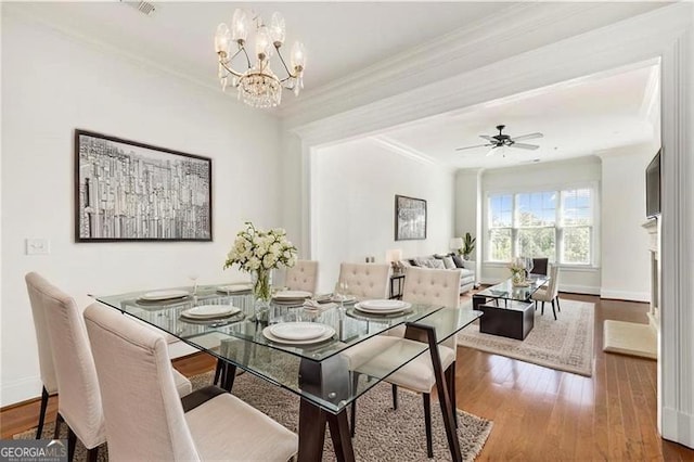 3635 Paces Cir Unit 1405, Atlanta, GA 30326 - dining space featuring crown molding, wood finished floors, a chandelier, baseboards, and ceiling fan