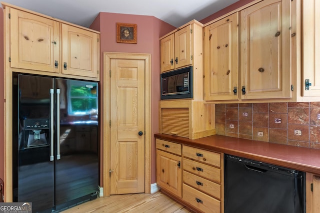 3498 Overland Trl, Ellenwood, GA 30294 - kitchen featuring black appliances, light brown cabinetry, dark countertops, backsplash, and light wood-style floors