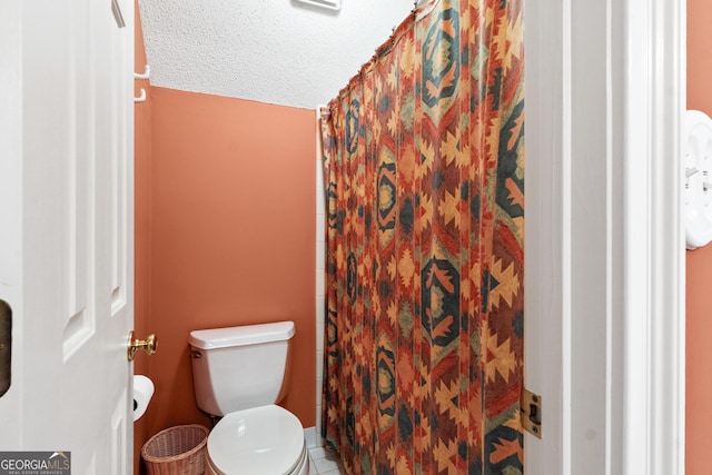 3498 Overland Trl, Ellenwood, GA 30294 - full bath with toilet, a shower with curtain, tile patterned floors, a textured ceiling, and lofted ceiling