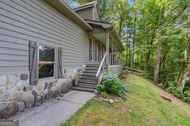 534 Mountainside Dr, Rabun Gap, GA 30568 - entrance to property with stone siding and a lawn