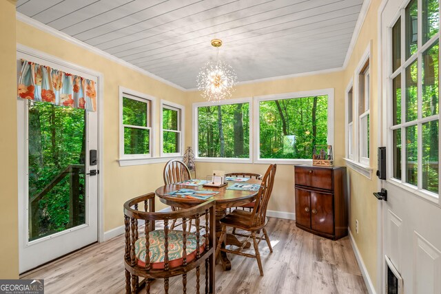 534 Mountainside Dr, Rabun Gap, GA 30568 - dining space featuring light wood-style floors, a chandelier, baseboards, crown molding, and wood ceiling