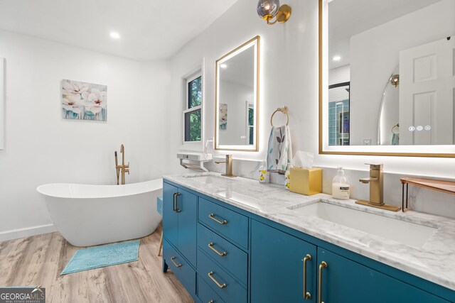 534 Mountainside Dr, Rabun Gap, GA 30568 - bathroom featuring wood finished floors, double vanity, a soaking tub, recessed lighting, and baseboards