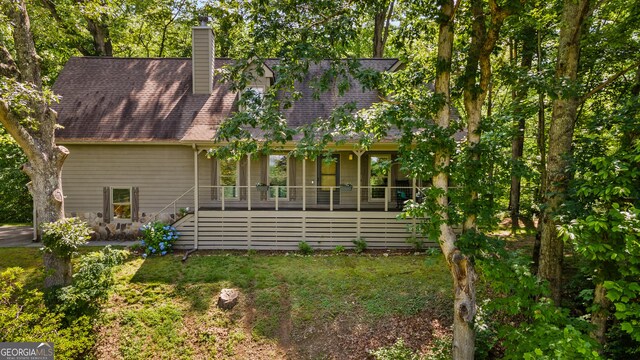 534 Mountainside Dr, Rabun Gap, GA 30568 - rear view of property with a porch, a chimney, stairway, and a lawn