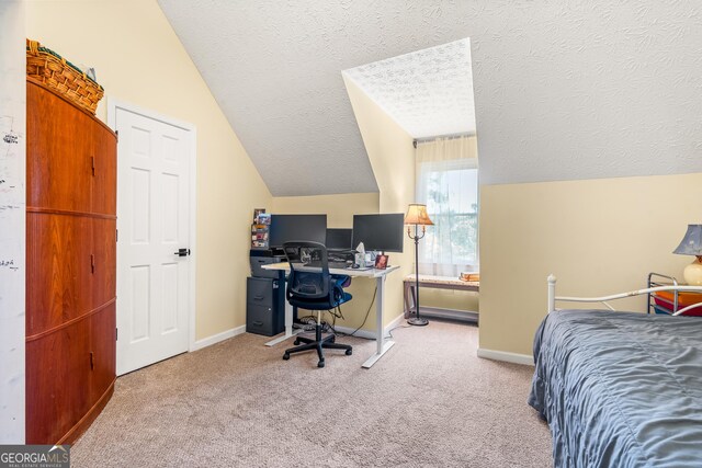 534 Mountainside Dr, Rabun Gap, GA 30568 - bedroom with lofted ceiling, a textured ceiling, baseboards, carpet flooring, and a desk