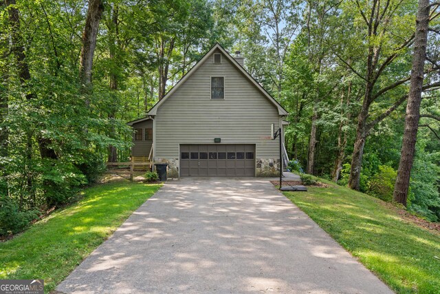 534 Mountainside Dr, Rabun Gap, GA 30568 - view of home's exterior featuring an attached garage, asphalt driveway, a yard, and a chimney