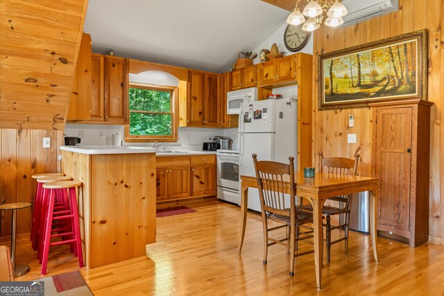 534 Mountainside Dr, Rabun Gap, GA 30568 - kitchen featuring white appliances, light wood-style flooring, wood walls, light countertops, and lofted ceiling