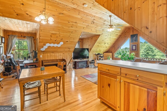 534 Mountainside Dr, Rabun Gap, GA 30568 - kitchen with wood walls, lofted ceiling, light wood-type flooring, open floor plan, and pendant lighting