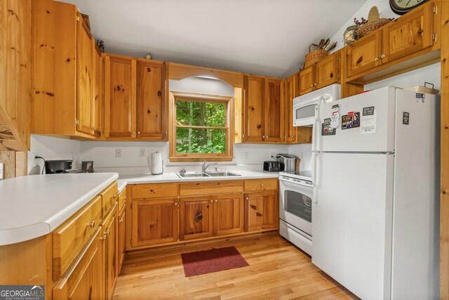 534 Mountainside Dr, Rabun Gap, GA 30568 - kitchen with white appliances, a sink, light wood finished floors, light countertops, and brown cabinets