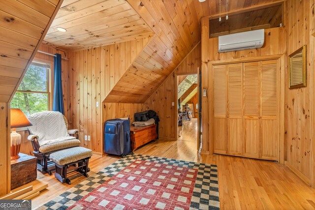 534 Mountainside Dr, Rabun Gap, GA 30568 - living area with a wall mounted AC, wood ceiling, wooden walls, hardwood / wood-style floors, and vaulted ceiling